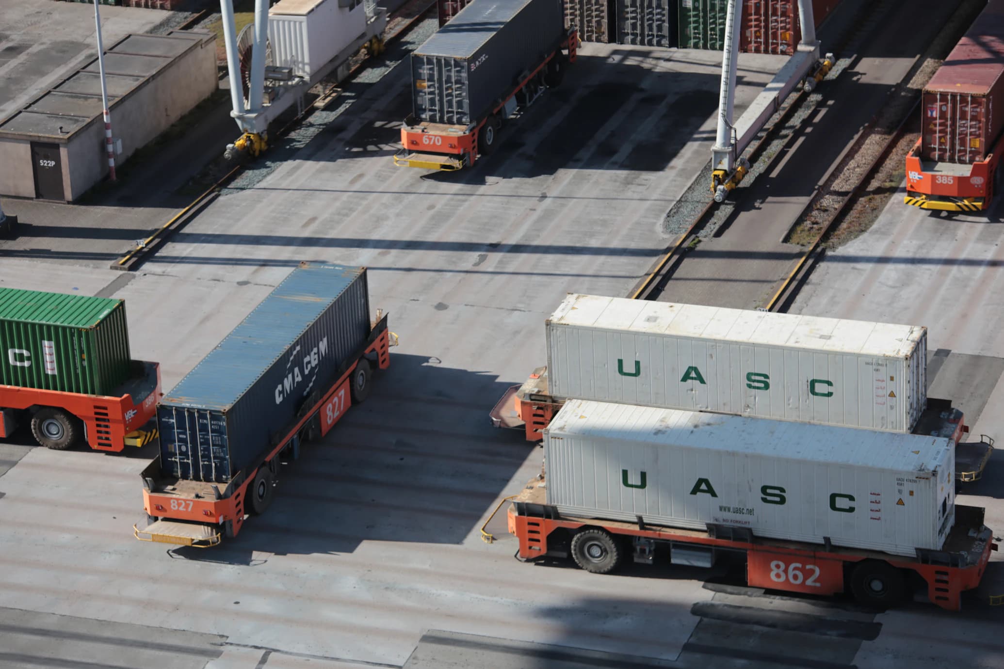 Plane flying over shipping containers